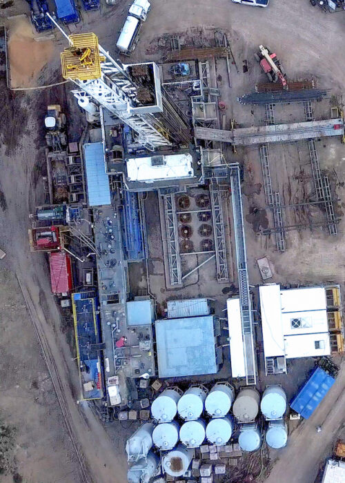 An amazing drone view of a drill rig perched on the side of a mountain in Colorado in the Springtime